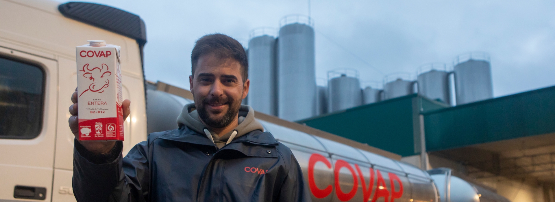 Carnicero de COVAP cortando con delicadeza jamón mientras una clienta le mira con asombro